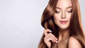 Young woman touching her healthy, strong hair | Melindas MedSap & Salon in North Myrtle Beach SC